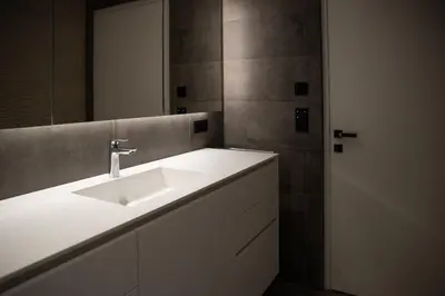 a bathroom with a white sink and a mirror at Trutscher Häusl in Villnöss - Chalet in den Dolomiten mit Blick auf die Geisler in Funes