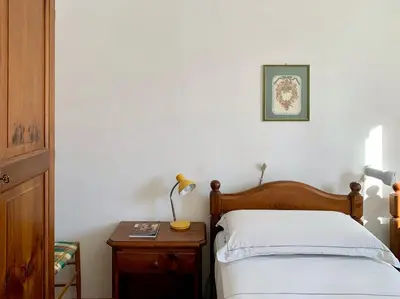 a bedroom with a bed and a table with a lamp at Apartment in the Center of Cortina in Cortina dʼAmpezzo