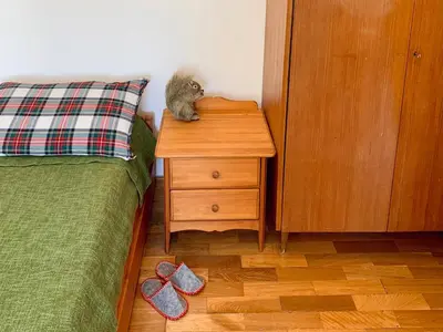 a stuffed animal sitting on a night stand next to a bed at Apartment in the Center of Cortina in Cortina dʼAmpezzo