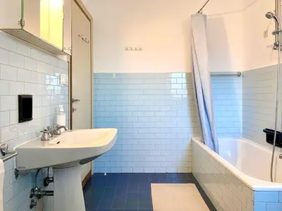 a bathroom with a sink and a bath tub and a sink at Apartment in the Center of Cortina in Cortina dʼAmpezzo