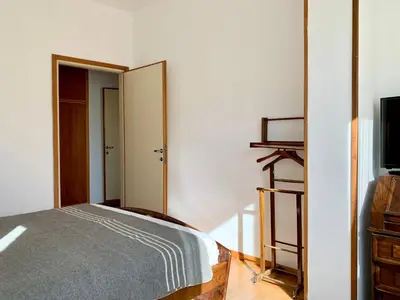 a bedroom with a bed and a mirror at Apartment in the Center of Cortina in Cortina dʼAmpezzo