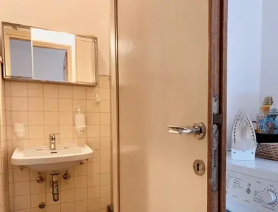 a bathroom with a sink and a mirror at Apartment in the Center of Cortina in Cortina dʼAmpezzo