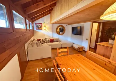 a living room with a couch and a table at HT - Mansarda panoramica nel cuore di San Vito in San Vito di Cadore