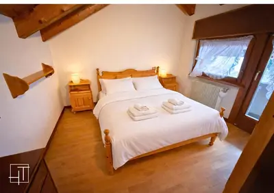 a bedroom with a bed with two towels on it at HT - Mansarda panoramica nel cuore di San Vito in San Vito di Cadore