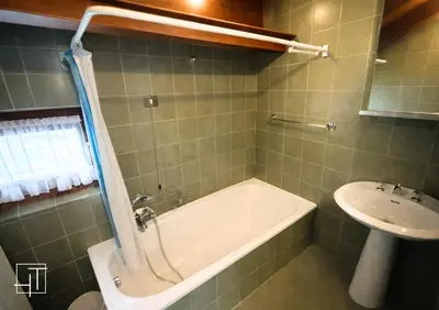 a bathroom with a bath tub and a sink at HT - Mansarda panoramica nel cuore di San Vito in San Vito di Cadore