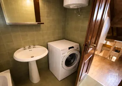 a bathroom with a washing machine and a sink at HT - Mansarda panoramica nel cuore di San Vito in San Vito di Cadore