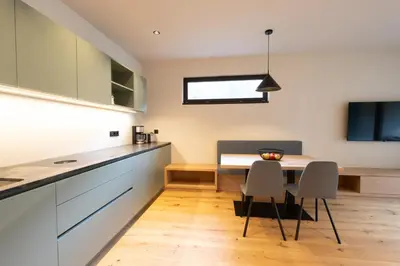 a kitchen and dining room with a table and chairs at Maratscherhof in Eppan an der Weinstrasse ST. Pauls