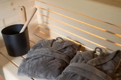 a pair of gloves sitting on a table next to a cup at Maratscherhof in Eppan an der Weinstrasse ST. Pauls