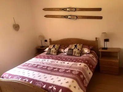 a bedroom with a bed with a doll laying on it at Fontanelle La Casa Dei Nonni in Elmo