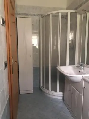 a bathroom with a sink and a glass shower at Fontanelle La Casa Dei Nonni in Elmo