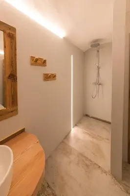a bathroom with a sink and a mirror at Latemar Fiemme Apartments 1 in Tesero