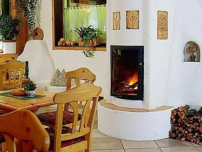 a living room with a fireplace and a table and chairs at Hotel Bosco Verde in Mareson