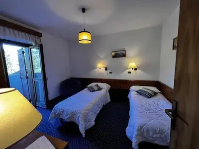 a room with two beds in a room at Hotel Bosco Verde in Mareson