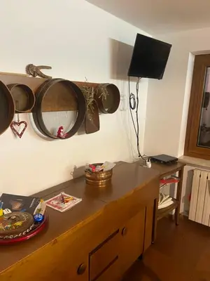 a room with a table with a mirror on the wall at Appartamento 8 Palazzina Maria in Ziano di Fiemme
