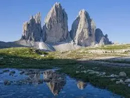 a reflection of a mountain in a body of water at Casa Similde e Casa Dolasilla in centro in Bolzano