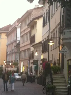 a group of people walking down a street with buildings at Casa Similde e Casa Dolasilla in centro in Bolzano