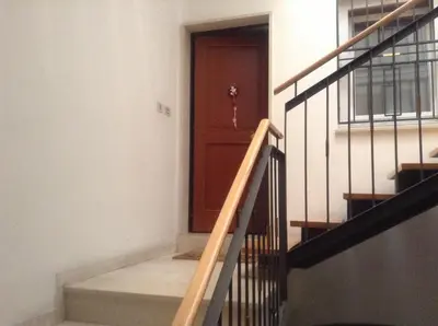 a stairway with a wooden door and a stair case at Casa Similde e Casa Dolasilla in centro in Bolzano