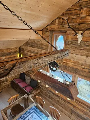 an overhead view of a cabin with wooden walls and a staircase at Maso delle Falesie in Rocca Pietore