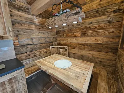 a wooden room with a wooden table in a cabin at Maso delle Falesie in Rocca Pietore