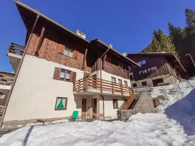 a building in the snow in front at Apartment Roacia-5 by Interhome in Alba di Canazei