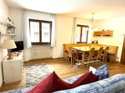 a living room with a table and a dining room at Apartment Roacia-5 by Interhome in Alba di Canazei