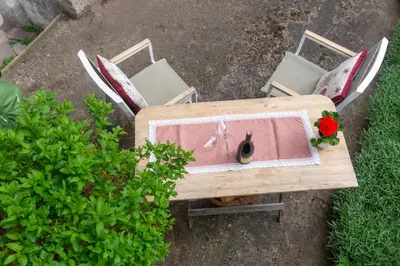 an overhead view of a bench with flowers on it at Dolomiapartments - Bosco Fontana 1 in Predazzo