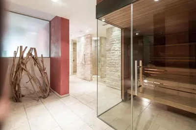 a glass walk in shower in a room at Alpine Hotel Ciasa Lara in La Villa