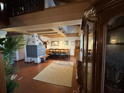 a living room with a table and a dining room at Appartamento Al Settimo Cielo in Tesero