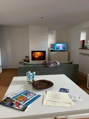 a living room with a couch and a table at Ca Costanza in Cortina dʼAmpezzo