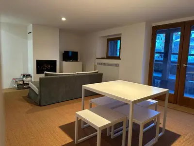 a living room with a couch and a table at Ca Costanza in Cortina dʼAmpezzo