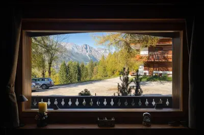 a window with a view of a mountain view at Cortina Olympic Alpine Holidays in Cortina dʼAmpezzo