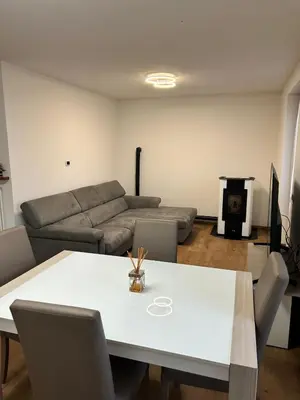 a living room with a table and a couch at Primule 2 Cavareno in Cavareno