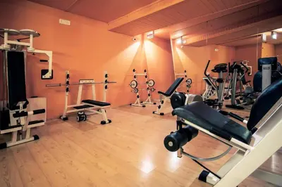 a gym with several tread machines in a room at Il Nido in Carano