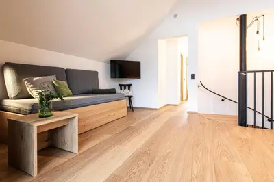 a living room with a couch and a tv at Senner Nature Stay in Riscone