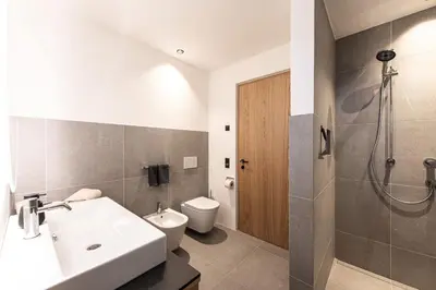 a bathroom with a sink and a toilet at Senner Nature Stay in Riscone