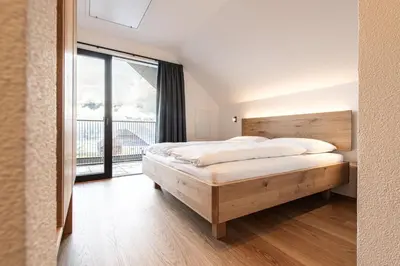 a bedroom with a bed and a large window at Senner Nature Stay in Riscone