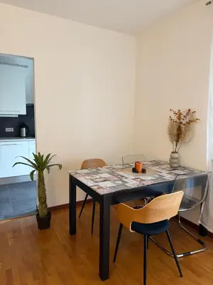 a dining room with a table and two chairs at Dolomites Home Bolzano in Bolzano