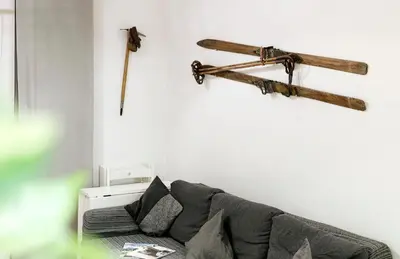 a living room with a couch and wooden beams on the wall at Casa Vitter - Central Apartment with Garage, Merano in Merano