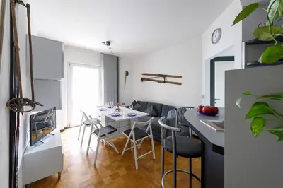 a kitchen and living room with a table and chairs at Casa Vitter - Central Apartment with Garage, Merano in Merano