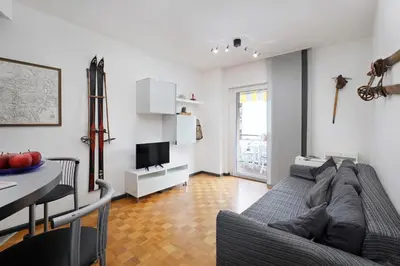 a living room with a couch and a table and a television at Casa Vitter - Central Apartment with Garage, Merano in Merano