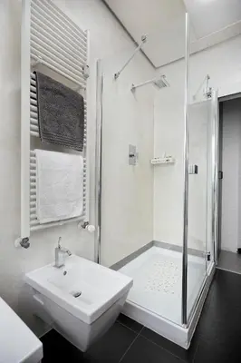 a white bathroom with a sink and a shower at Casa Vitter - Central Apartment with Garage, Merano in Merano