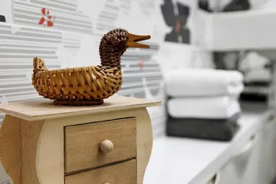 a wooden duck sitting on top of a drawer at Casa Vitter - Central Apartment with Garage, Merano in Merano