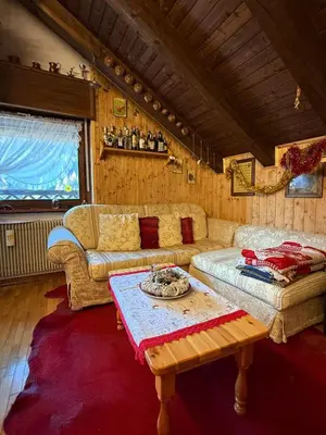 a living room with a couch and a table at Red Alpine Olympic Apartment near Cortina in San Vito di Cadore