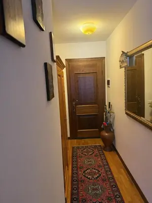a hallway with a door and a rug on the floor at Red Alpine Olympic Apartment near Cortina in San Vito di Cadore