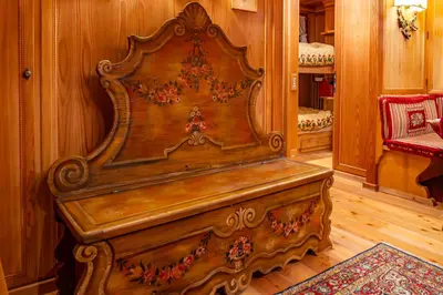 a large wooden bench sitting in a room at Alpine Living Cortina in Cortina dʼAmpezzo