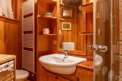 a bathroom with a sink and a shower and a mirror at Alpine Living Cortina in Cortina dʼAmpezzo