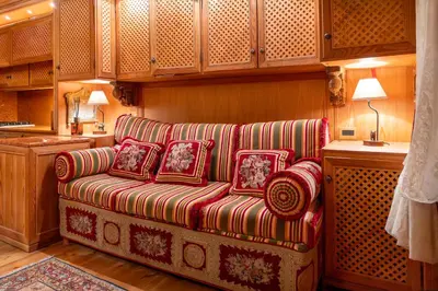 a living room with a couch with pillows on it at Alpine Living Cortina in Cortina dʼAmpezzo