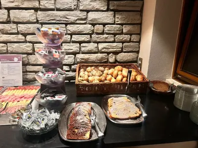 a table topped with lots of different types of food at Hotel Angerer in Bressanone