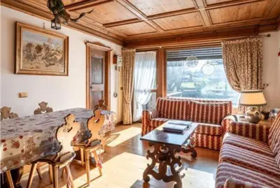a bedroom with a bed and a couch and a table at ca peziè in Zuel