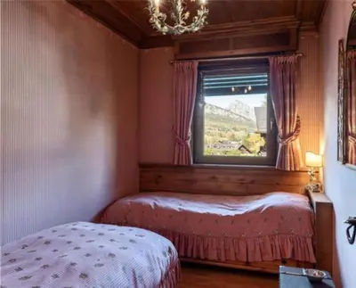 a bedroom with a bed and a window with a view at ca peziè in Zuel